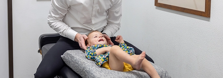 Chiropractor Prosper TX Staff Member Adjusting Child