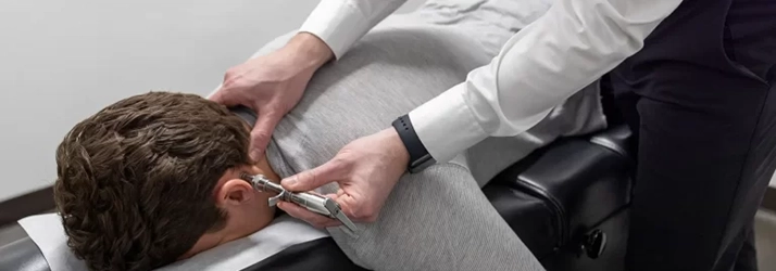 Chiropractor Prosper TX Staff Member Adjusting Man's Neck